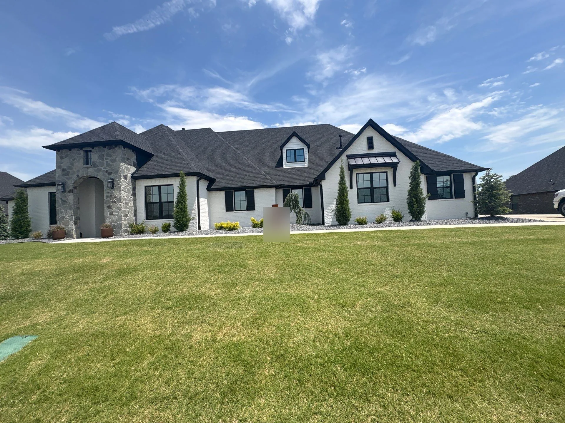 Premium dark architectural shingle roof on a Claremore modern farmhouse