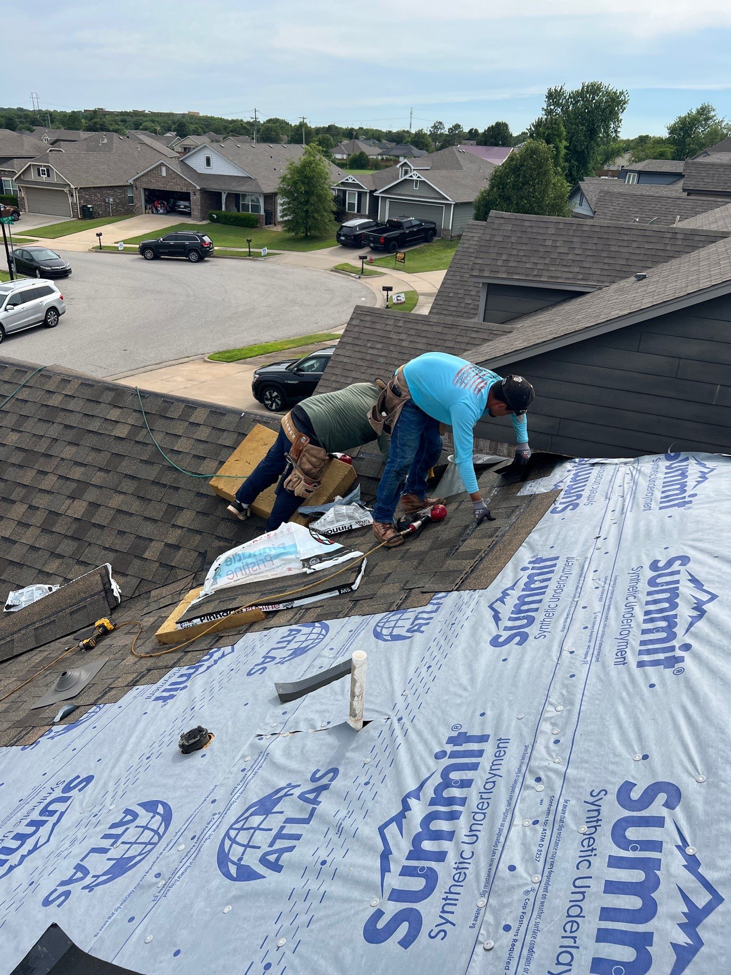 FireHouse Roofing crew installing Atlas shingles over Summit synthetic underlayment on an Owasso home