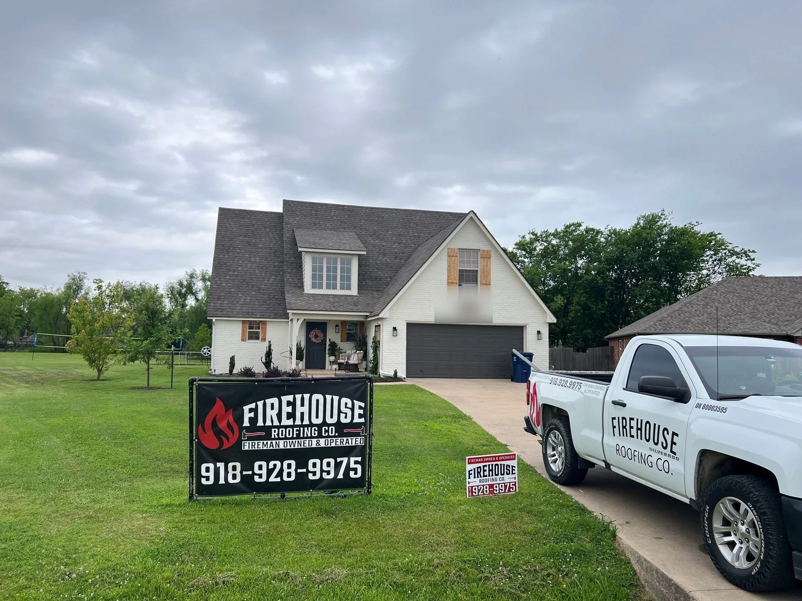 FireHouse Roofing truck on the driveway of a Collinsville home during a roof replacement project