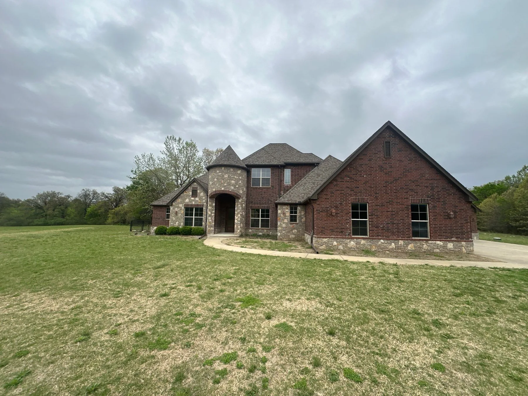 Completed roof replacement on a Coweta brick and stone two-story home