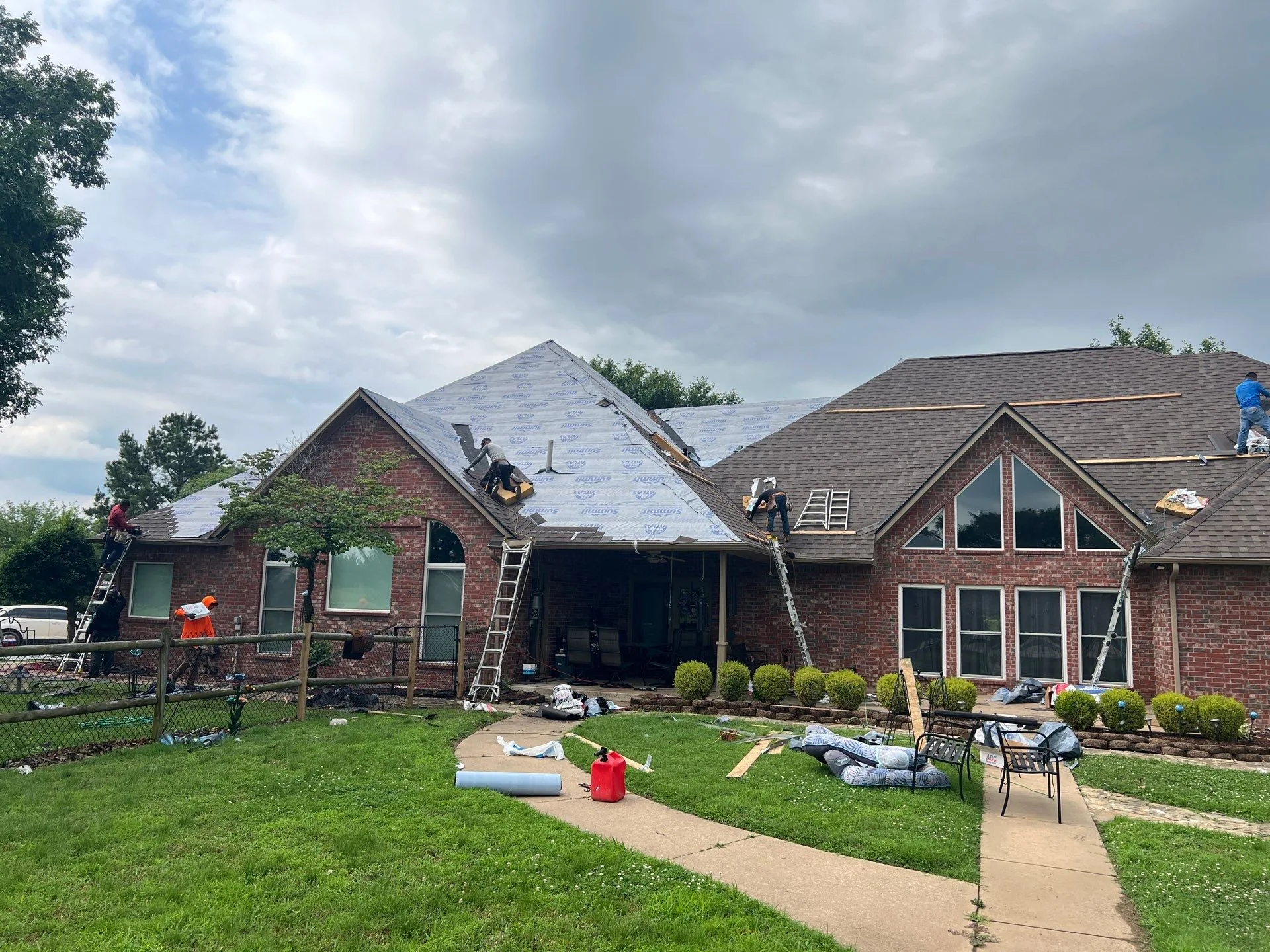 Synthetic underlayment going down during a FireHouse roof replacement in Claremore