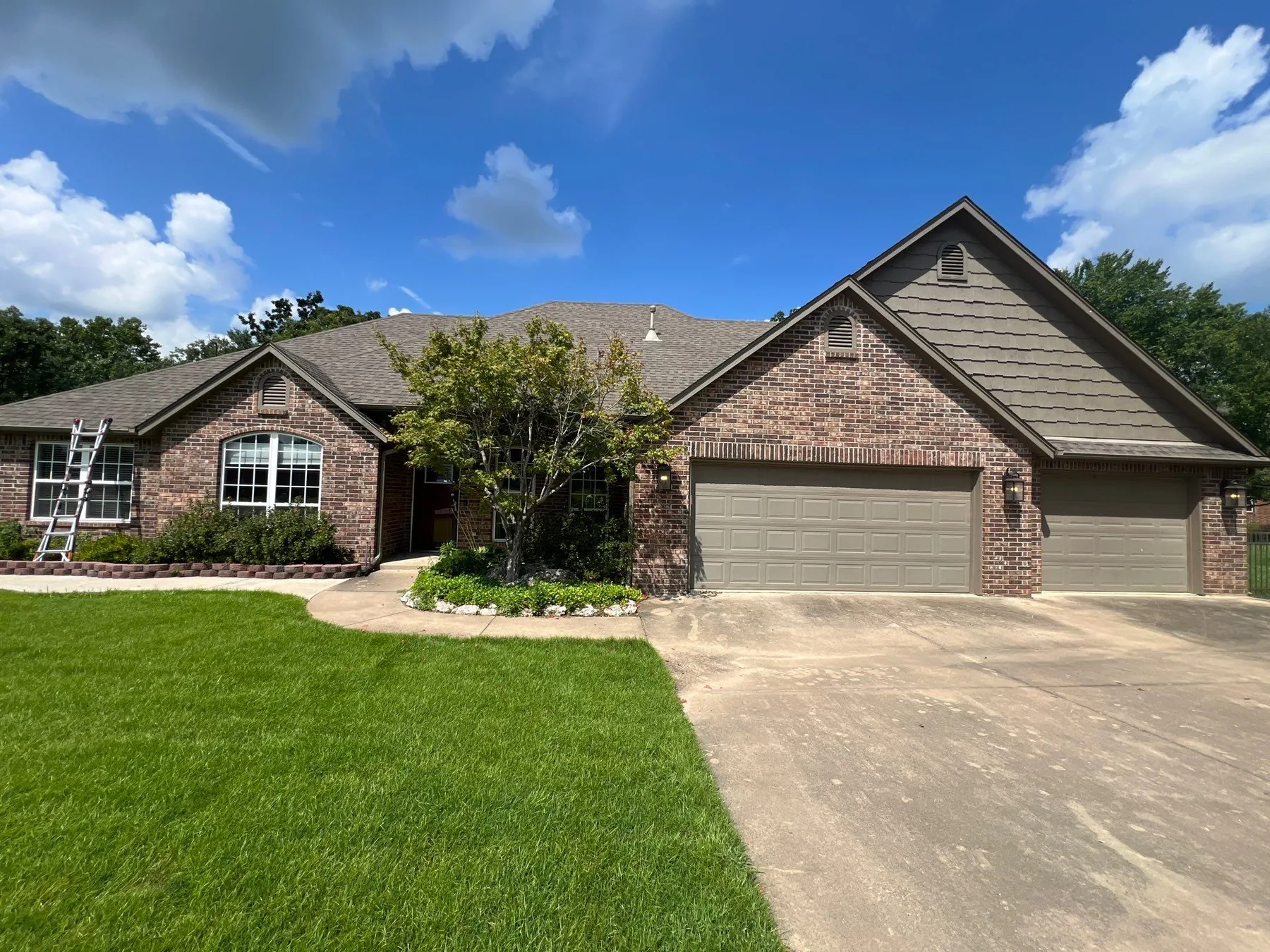 Completed FireHouse Roofing roof replacement on a Coweta brick home with a three-car garage