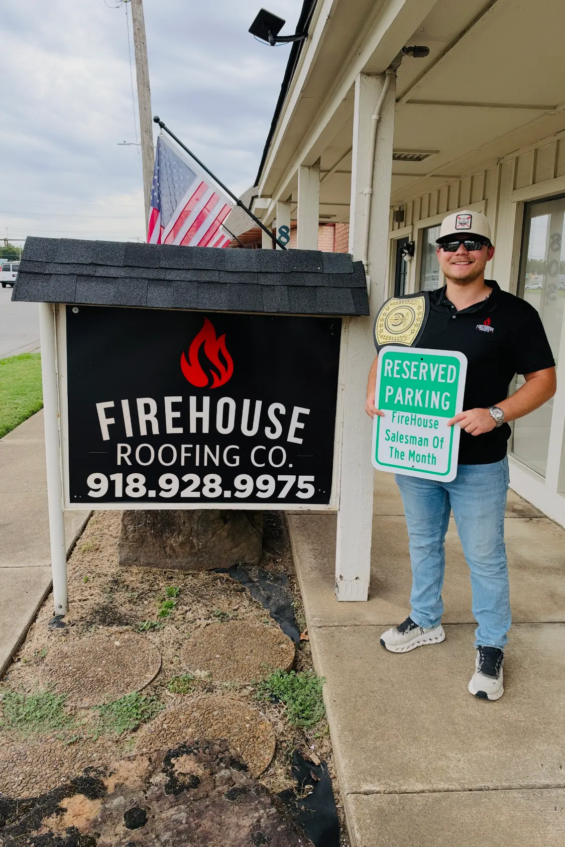 FireHouse Roofing Salesman of the Month standing by the company sign in Broken Arrow, Oklahoma