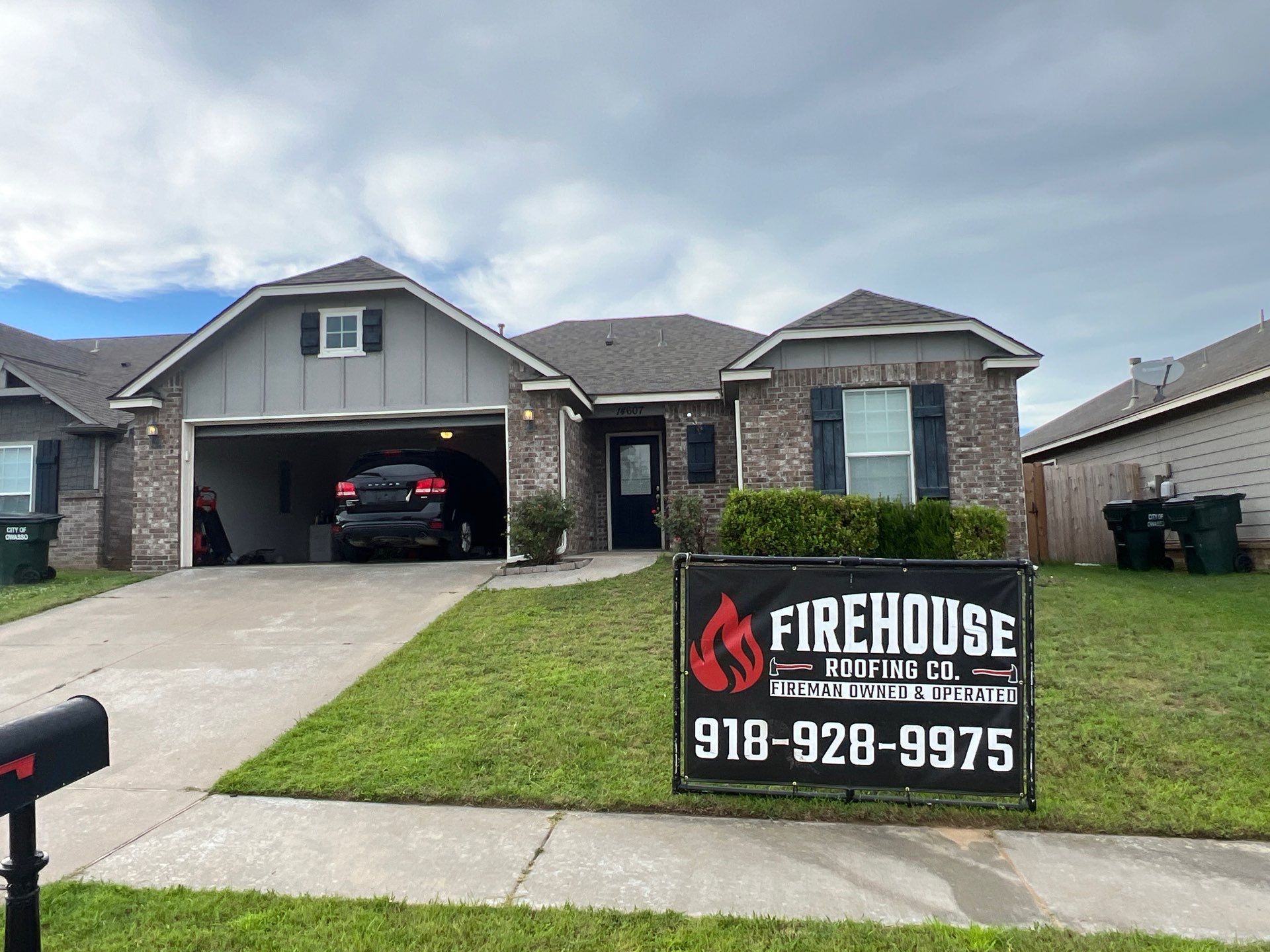 Completed FireHouse Roofing Co. roof replacement on a brick home in Owasso, Oklahoma