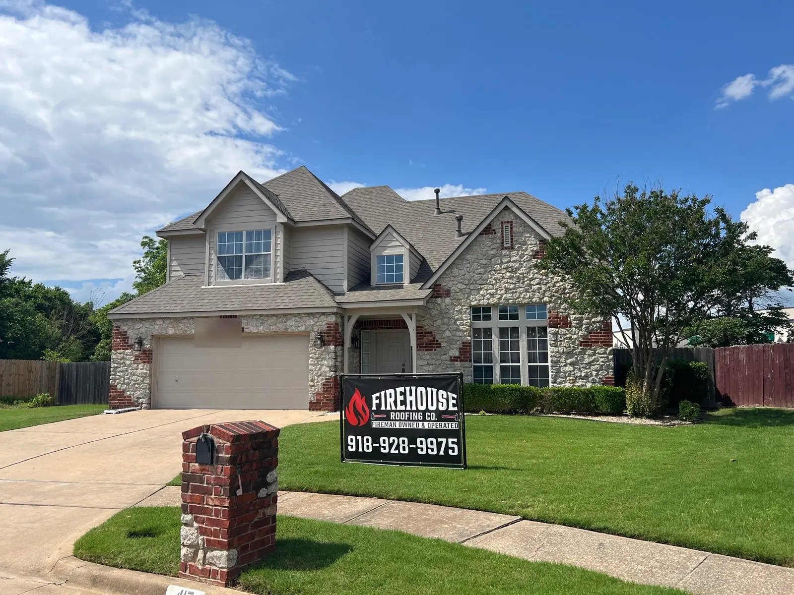 Completed roof replacement by FireHouse Roofing on a Broken Arrow stone and siding home