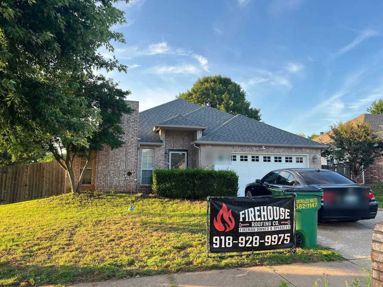 Completed FireHouse Roofing roof replacement on a Bixby brick ranch home with yard sign