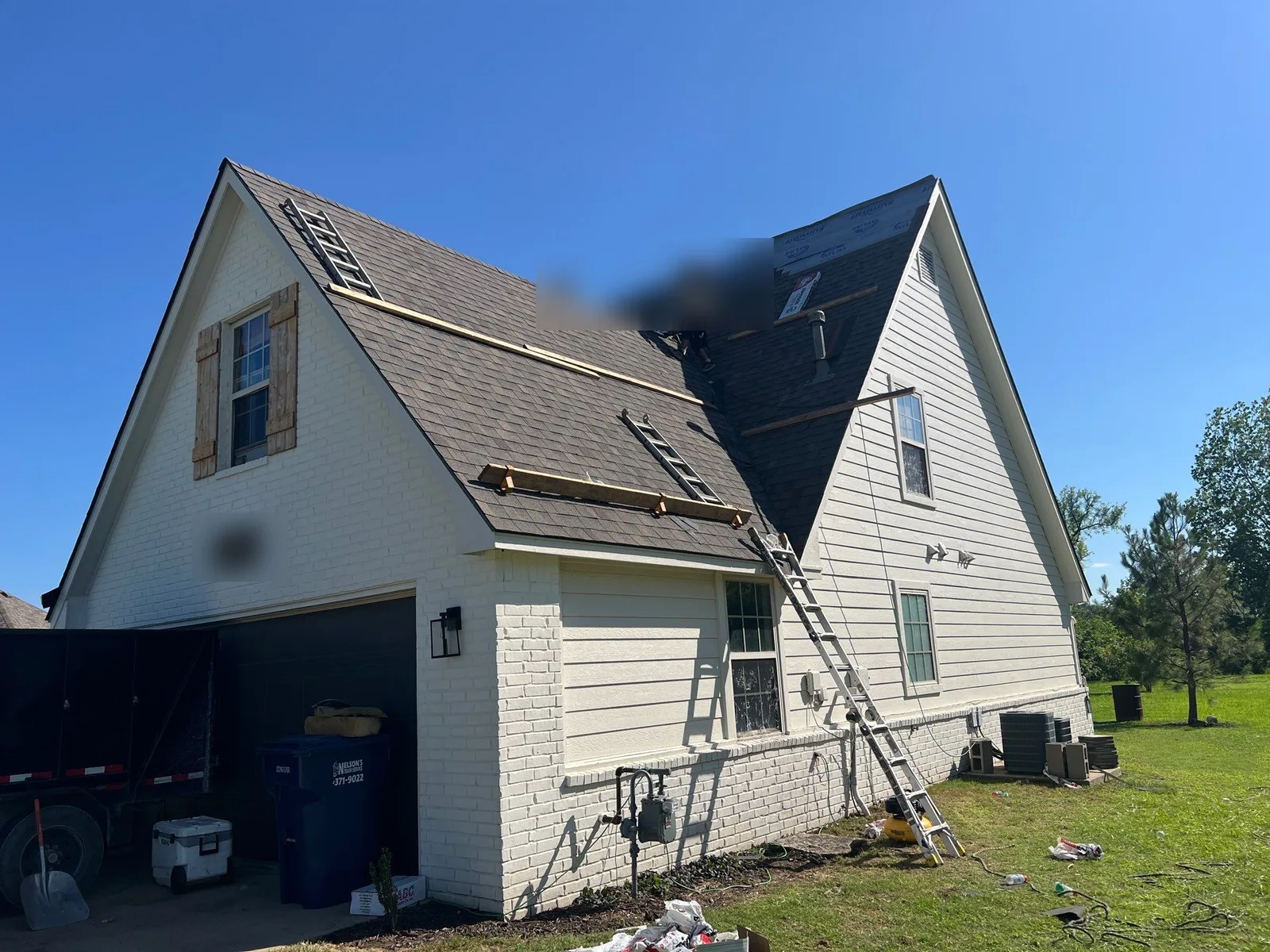 FireHouse Roofing crew performing a roof tear-off on a Collinsville home with synthetic underlayment going down