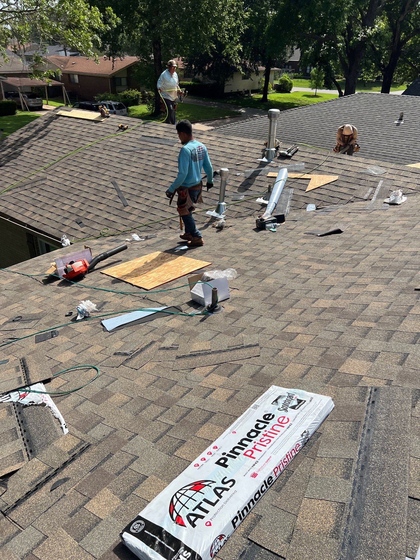 FireHouse Roofing crew during a roof replacement, installing Atlas Pinnacle Pristine architectural shingles