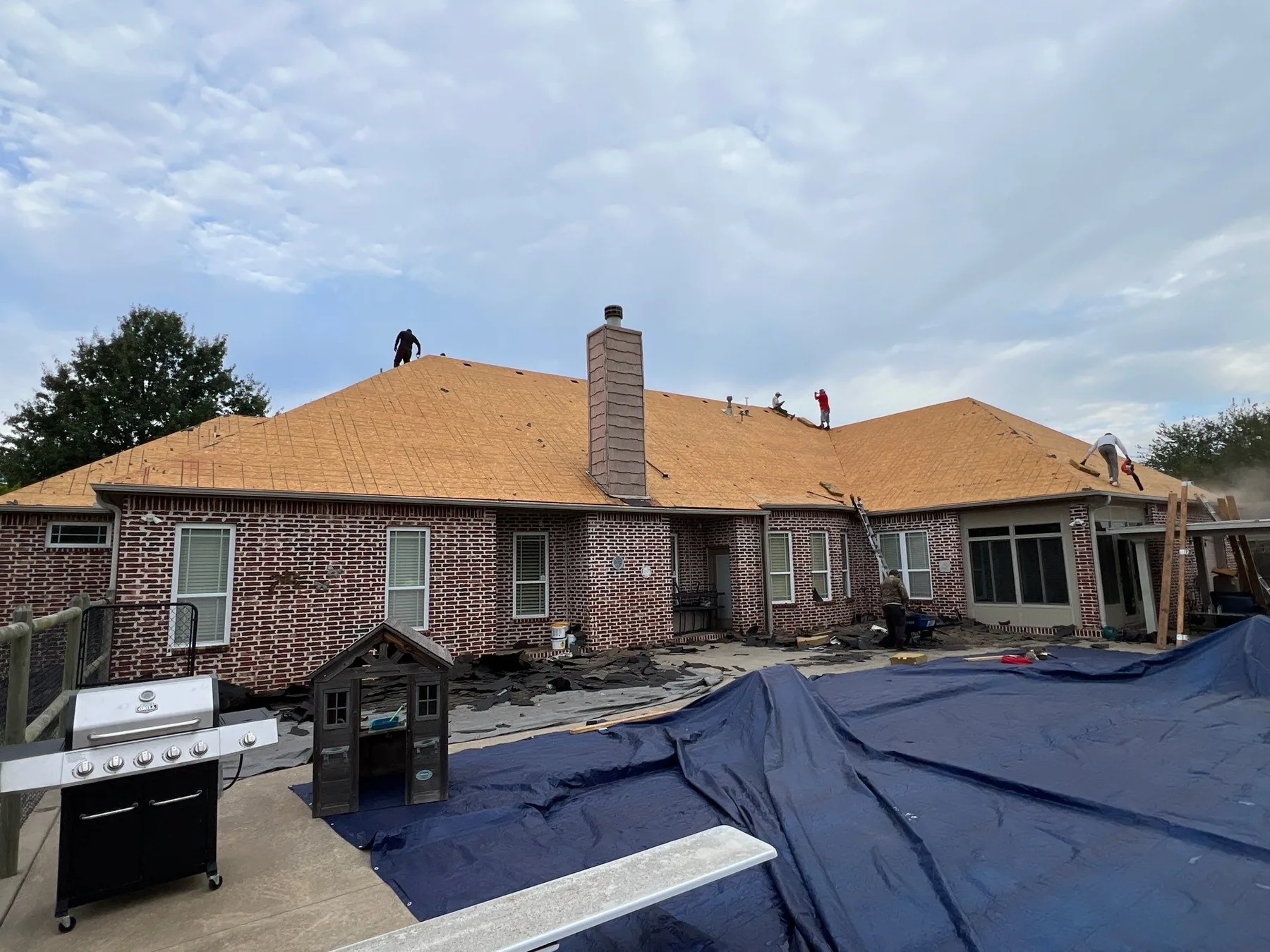 FireHouse Roofing crew installing new decking during a Jenks roof replacement