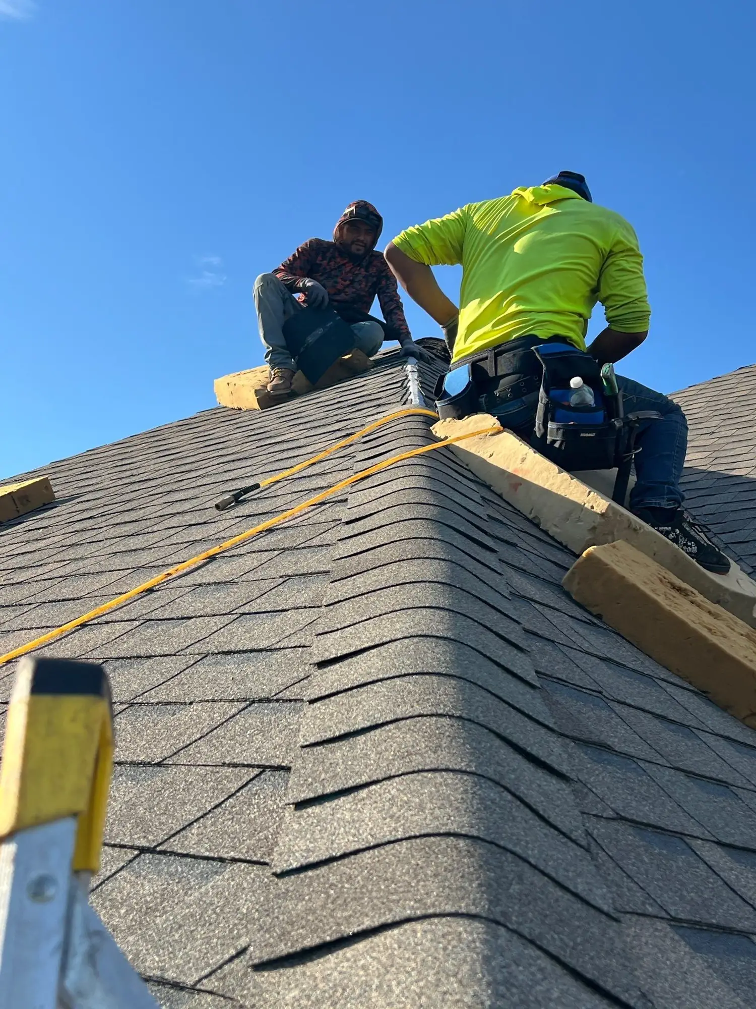 FireHouse Roofing crew working along the ridge during a Jenks roof replacement