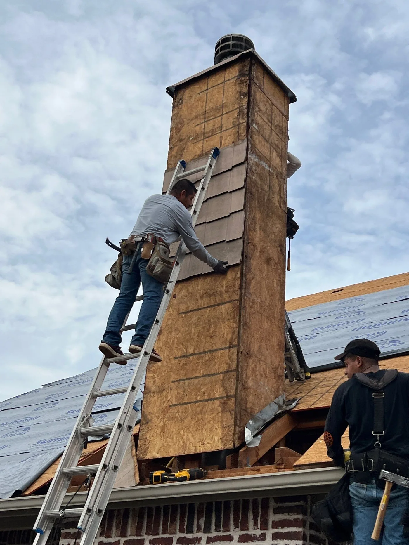 Chimney and underlayment detail during a Jenks roof replacement